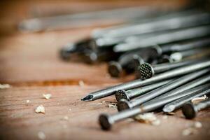 A bunch of nails on the table. photo