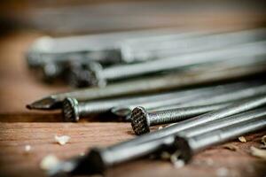 A bunch of nails on the table. photo