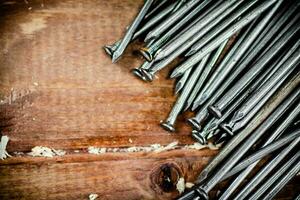 A bunch of nails on the table. photo