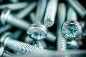 A pile of bolts. Macro background. photo