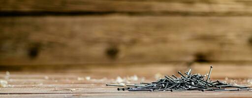 A pile of nails on the table. photo