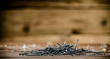 A pile of nails on the table. photo