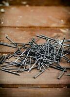 A pile of nails on the table. photo