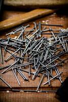 A pile of nails on the table. photo