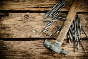 A bunch of nails on the table. photo