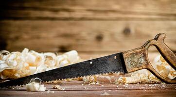 Hand saw with wooden shavings. photo