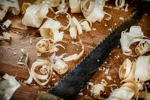 Hand saw with wooden shavings. photo