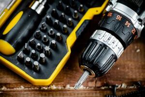 Working tools. Screwdriver bits. On a wooden background. photo