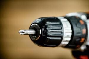 Working tool. Screwdriver. On a wooden background. photo