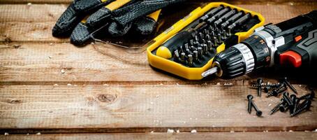 Working tools. Screwdriver bits. On a wooden background. photo