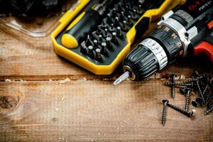 Working tools. Screwdriver bits. On a wooden background. photo