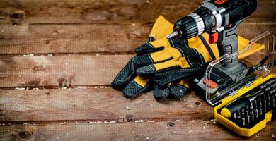 Working tools. Screwdriver bits. On a wooden background. photo