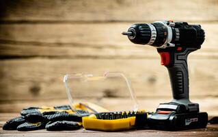 Working tools. Screwdriver bits. On a wooden background. photo