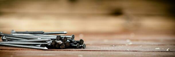 A pile of nails on the table. photo