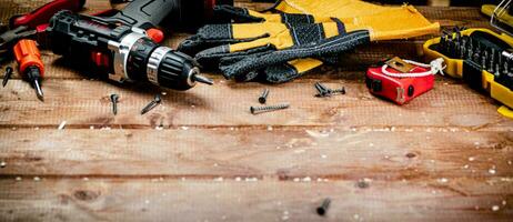 Working tool. Screwdriver with self-tapping screws on the table. photo