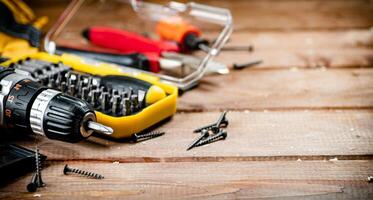 Working tool. Screwdriver with self-tapping screws on the table. photo