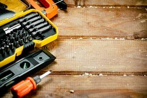 Working tools. Screwdriver bits. On a wooden background. photo