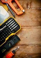 Working tools. Screwdriver bits. On a wooden background. photo