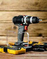 Working tools. Screwdriver bits. On a wooden background. photo