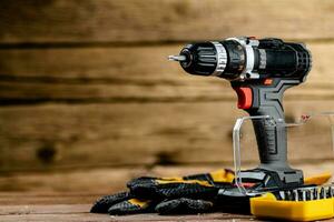 Working tools. Screwdriver bits. On a wooden background. photo