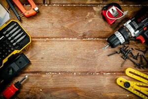 Working tools. Screwdriver bits. On a wooden background. photo