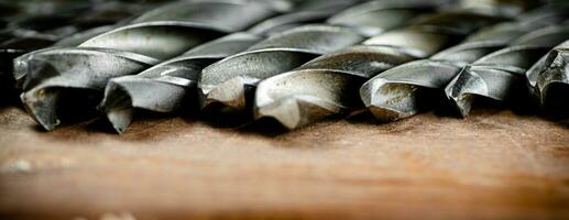 Drill bits for drills on the table. photo