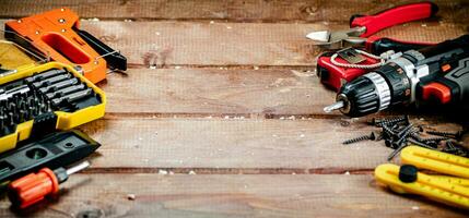 Working tools. Screwdriver bits. On a wooden background. photo