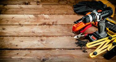 Working tool. Screwdriver with self-tapping screws on the table. photo