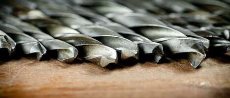 Drill bits for drills on the table. photo