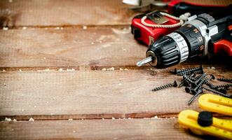 Working tool. Screwdriver with self-tapping screws on the table. photo