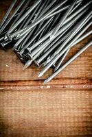 A pile of nails on the table. photo