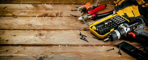 Working tool. Screwdriver with self-tapping screws on the table. photo