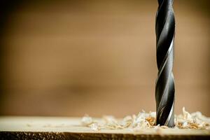 Piece of wood is drilled with shavings. photo