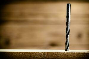 Piece of wood is drilled with shavings. photo