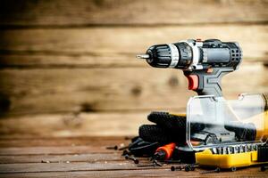 Working tool. Screwdriver with self-tapping screws on the table. photo