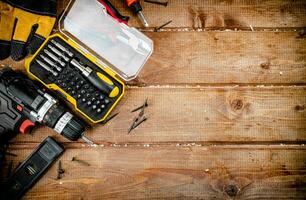 Working tool. Screwdriver with self-tapping screws on the table. photo