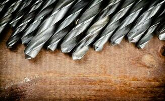 Drill bits for drills on the table. photo