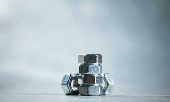 Working tool. Metal nuts on the table. photo