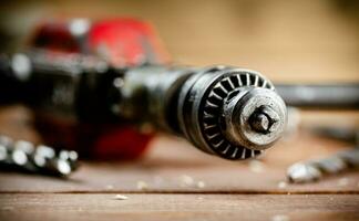 Drill with drills on the table. photo