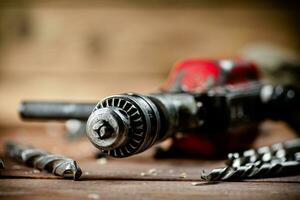 Drill with drills on the table. photo