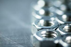 Working tool. Metal nuts on the table. photo