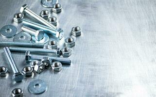 Working tool. Nuts and bolts on the table. photo