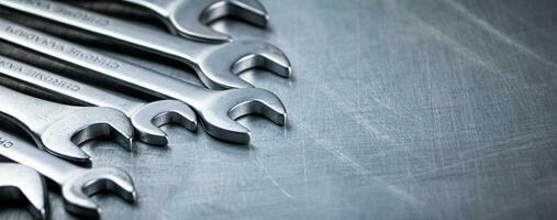 Metal wrench on the table. photo