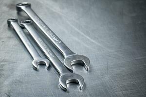 Metal wrench on the table. photo