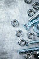 Working tool. Nuts and bolts on the table. photo