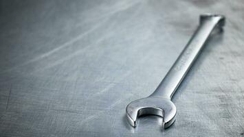 Metal wrench on the table. photo