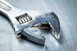 Metal wrench on the table. photo