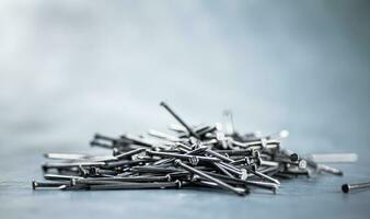 A bunch of nails on the table. photo