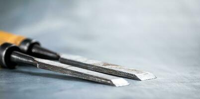 Chisel on wood on the table. photo