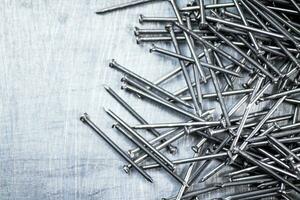 A bunch of nails on the table. photo